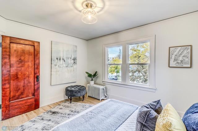 bedroom featuring wood-type flooring and radiator