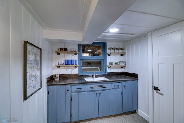 bar featuring sink and wood walls