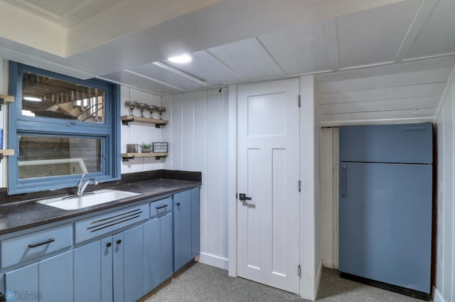 bar with stainless steel refrigerator, sink, carpet, and wooden walls