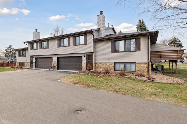 view of front of house with a garage and cooling unit