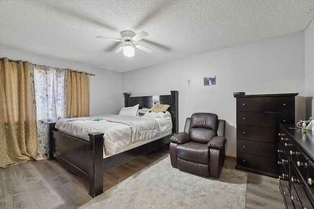 bedroom featuring wood-type flooring, a textured ceiling, and ceiling fan