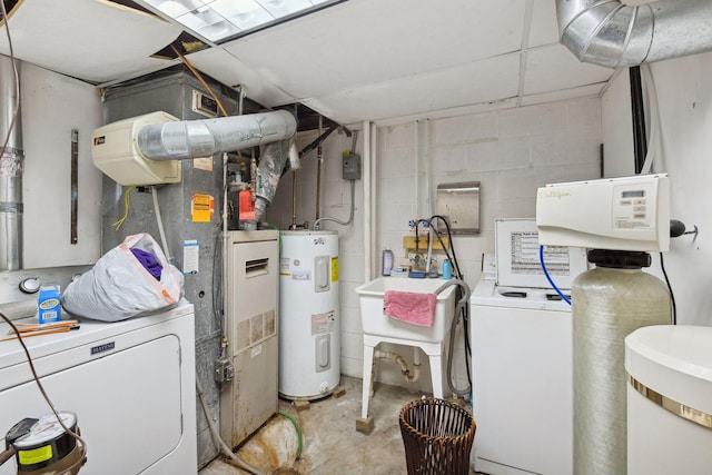 clothes washing area featuring washer and clothes dryer and electric water heater