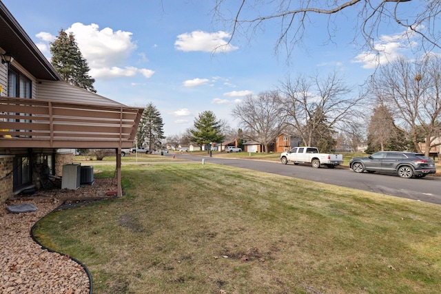 view of yard featuring a wooden deck and central AC