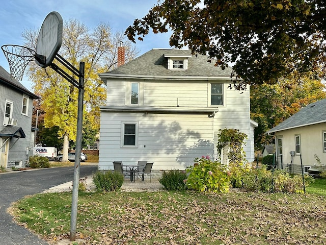 rear view of house with a patio and cooling unit