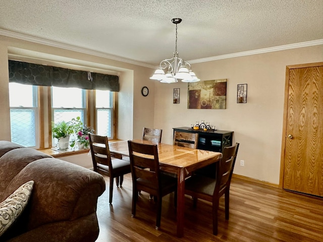 dining room with hardwood / wood-style floors, crown molding, a textured ceiling, and an inviting chandelier