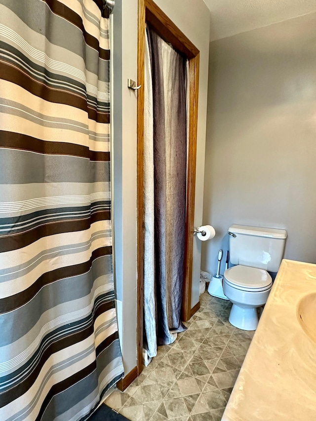 bathroom featuring vanity and toilet