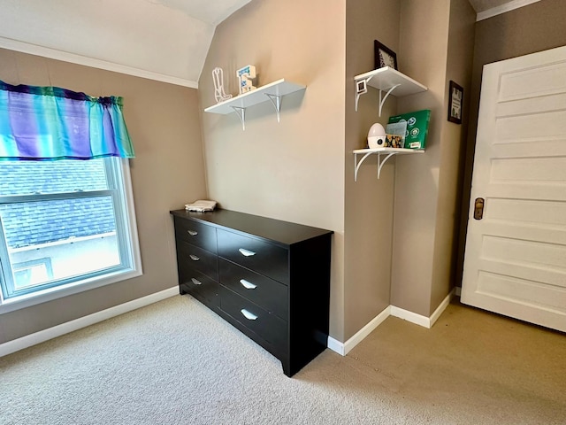 walk in closet featuring light carpet and lofted ceiling