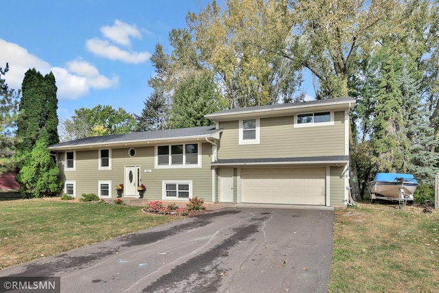 bi-level home featuring a front lawn and a garage