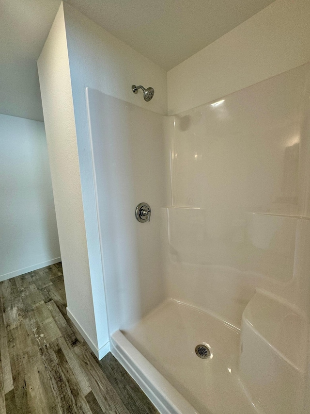 bathroom featuring walk in shower and hardwood / wood-style floors