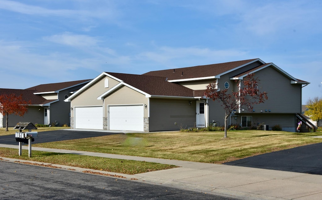 view of front of property with a front lawn and a garage