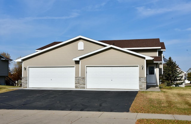 view of front facade with a garage and a front lawn