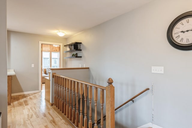 stairway with baseboards and wood finished floors