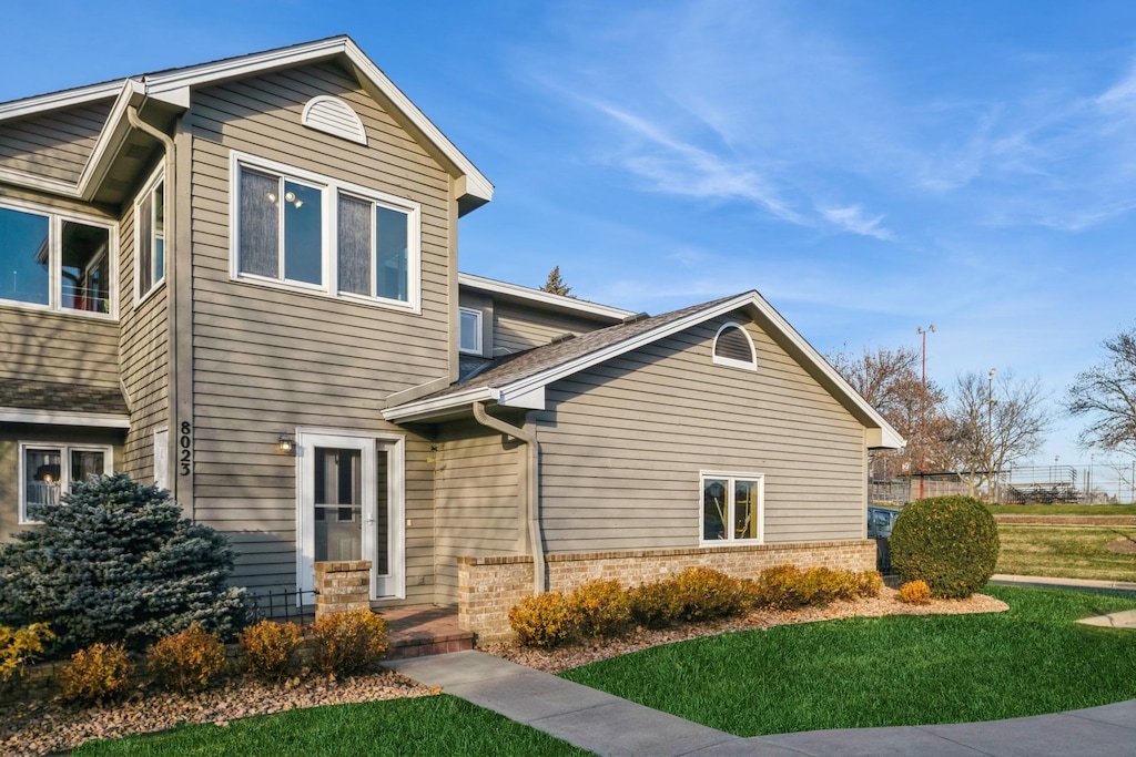 8023 110th St, Bloomington, MN 55438 - view of front facade featuring a front lawn and brick siding