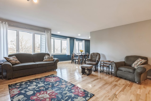 living room featuring recessed lighting, wood finished floors, and baseboards