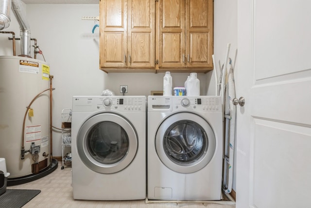 laundry room featuring water heater, cabinet space, washer and dryer, and light floors