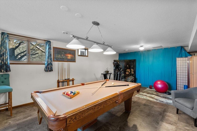 playroom with a textured ceiling and billiards