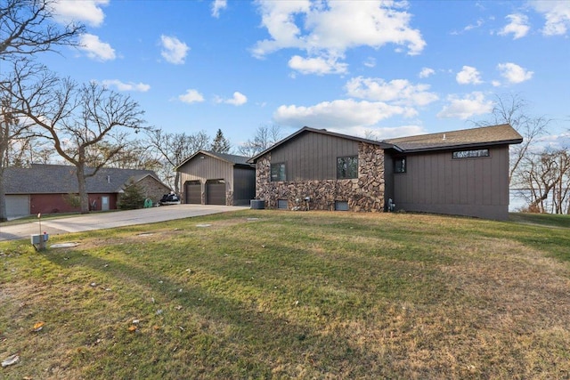 ranch-style home with a garage and a front lawn