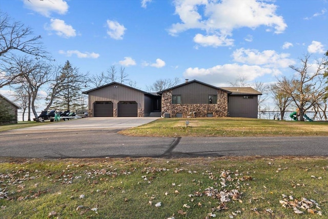 ranch-style house with a garage and a front lawn