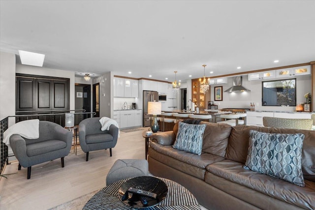 living room featuring light hardwood / wood-style flooring and an inviting chandelier