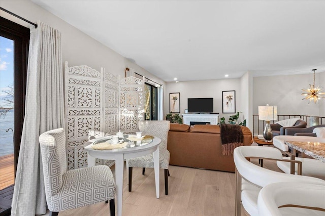 dining room featuring light hardwood / wood-style flooring and a notable chandelier