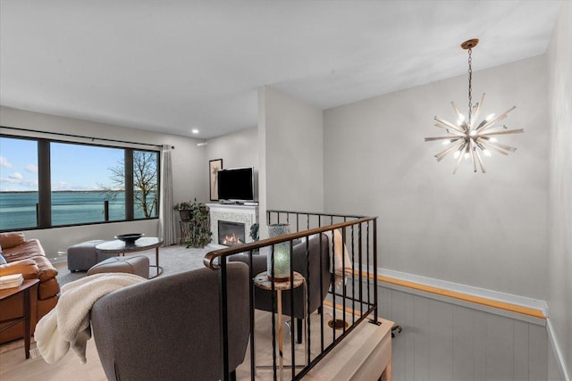 living room featuring a water view and a notable chandelier