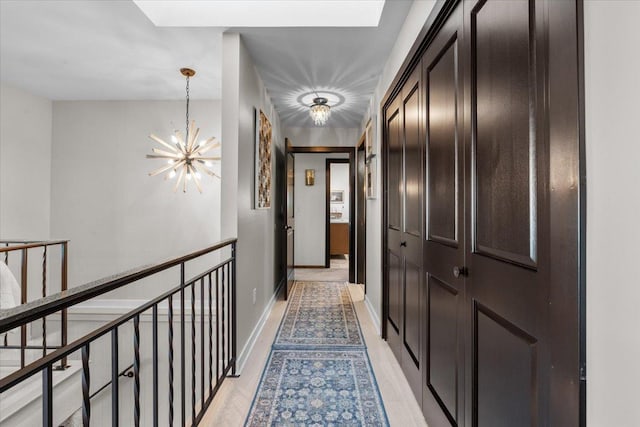 hallway featuring a chandelier and light hardwood / wood-style flooring