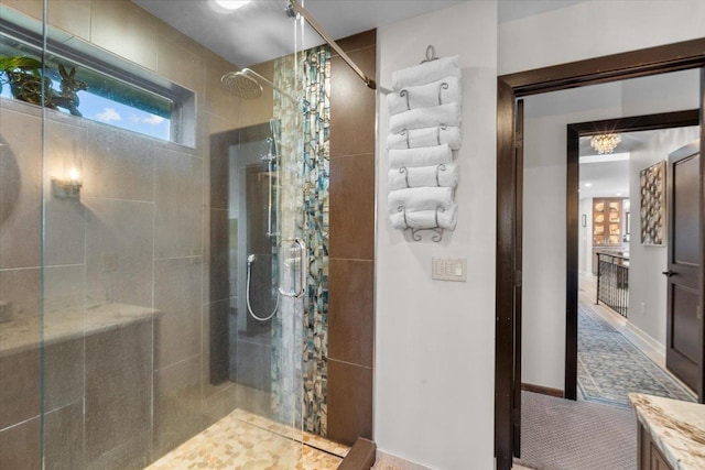 bathroom featuring a tile shower and vanity