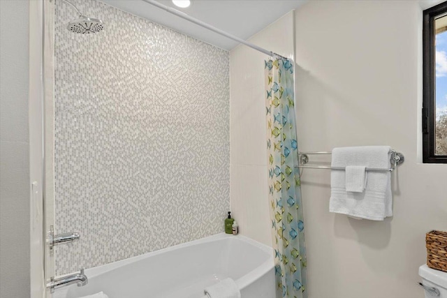 bathroom featuring toilet and shower / tub combo