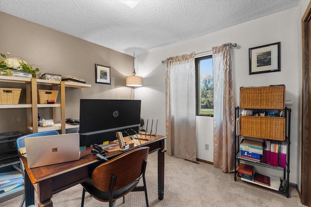 carpeted office featuring a textured ceiling