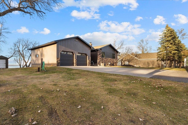 view of side of home with a lawn and a garage