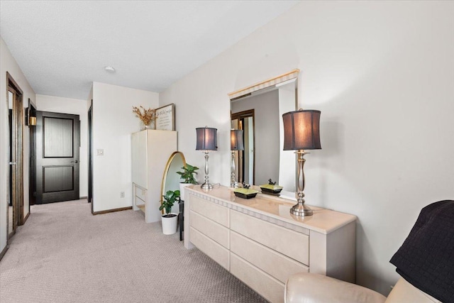 hall featuring light carpet and baseboards