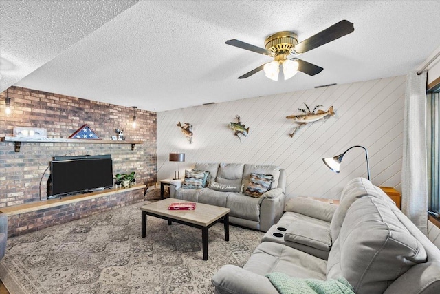 living area featuring a ceiling fan and a textured ceiling