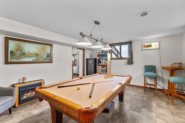 recreation room with baseboards, billiards, a textured ceiling, and a fireplace