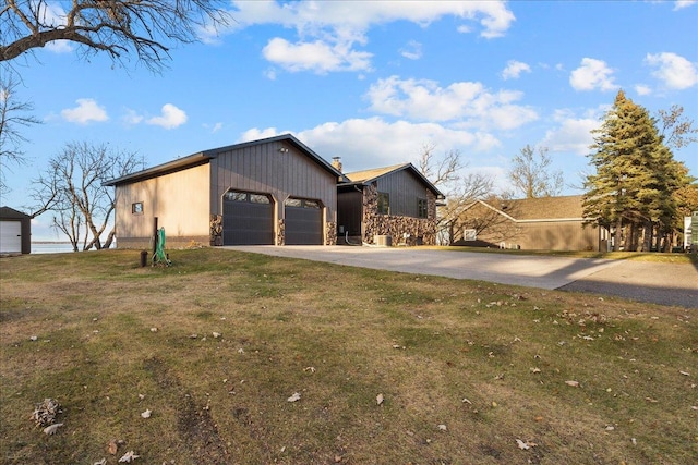 view of front of home featuring a chimney, a front yard, and concrete driveway