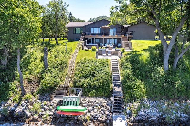 29777 Highland Loop, Battle Lake, MN 56515 - back of house featuring stairs, a deck, and a lawn
