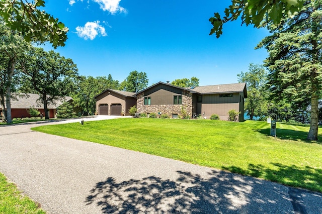 29777 Highland Loop, Battle Lake, MN 56515 - view of front of home with stone siding, a front lawn, concrete driveway, and a garage