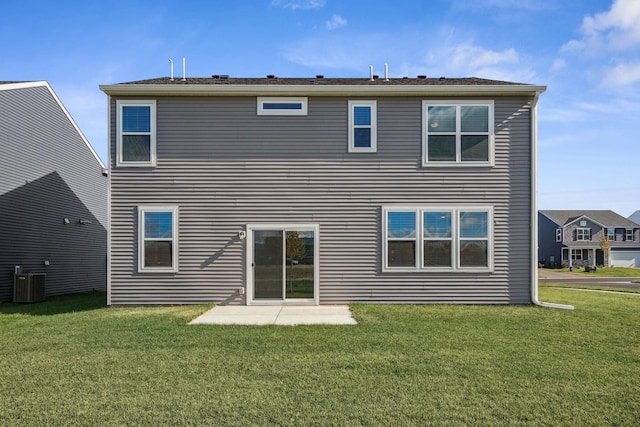 rear view of house featuring a yard and cooling unit