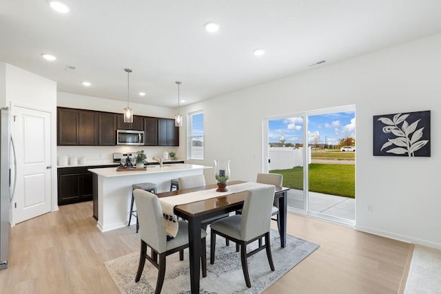 dining area with light hardwood / wood-style flooring