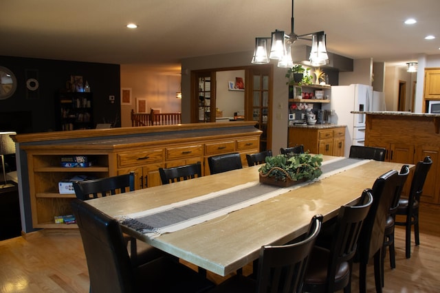 dining space featuring recessed lighting and light wood-type flooring