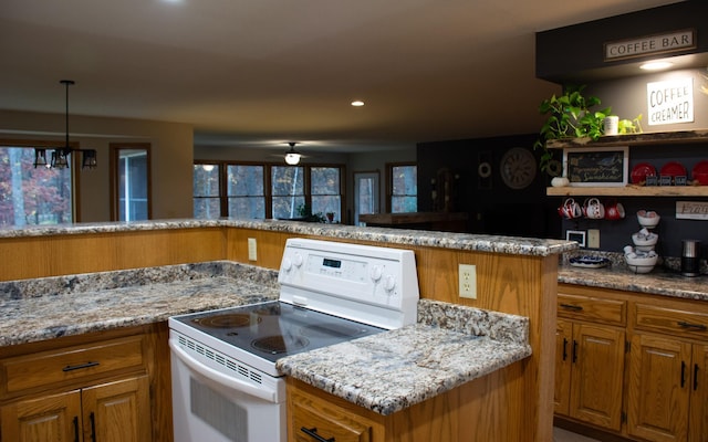 kitchen with ceiling fan, light stone counters, recessed lighting, brown cabinets, and electric stove