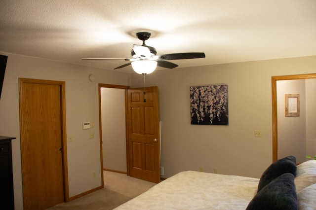 bedroom with baseboards, light carpet, and a ceiling fan