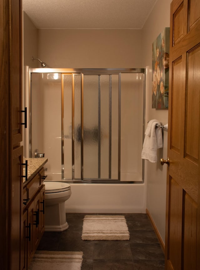 full bathroom with baseboards, toilet, vanity, combined bath / shower with glass door, and a textured ceiling