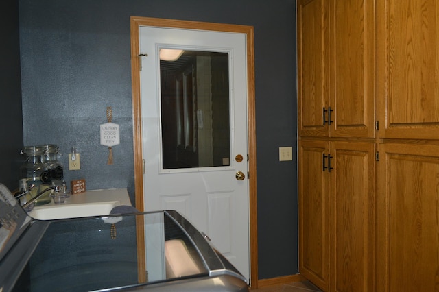 interior space with baseboards and a sink