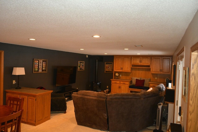 living room with recessed lighting, light colored carpet, and a textured ceiling