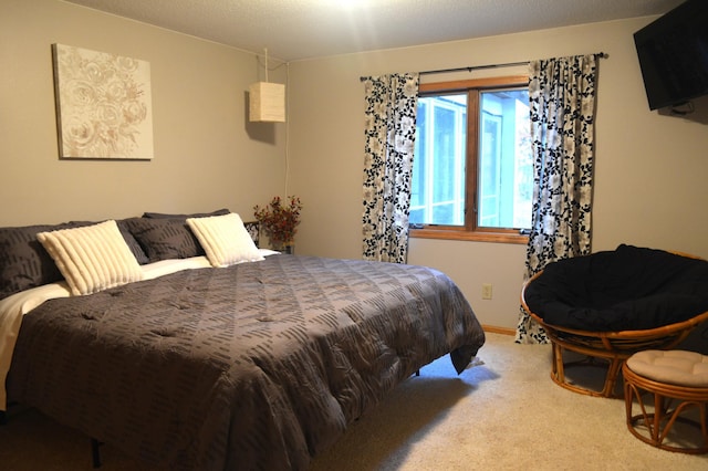 carpeted bedroom featuring baseboards