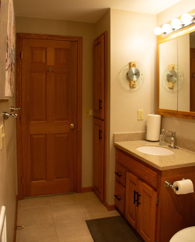 bathroom featuring baseboards, vanity, and tile patterned flooring