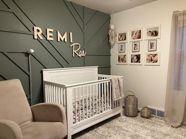 bedroom with carpet flooring and a crib