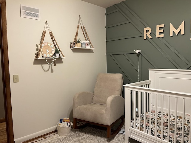 carpeted bedroom with a nursery area