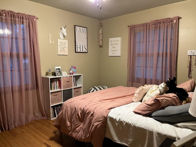 bedroom with hardwood / wood-style flooring