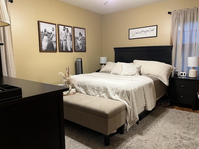 bedroom with hardwood / wood-style flooring